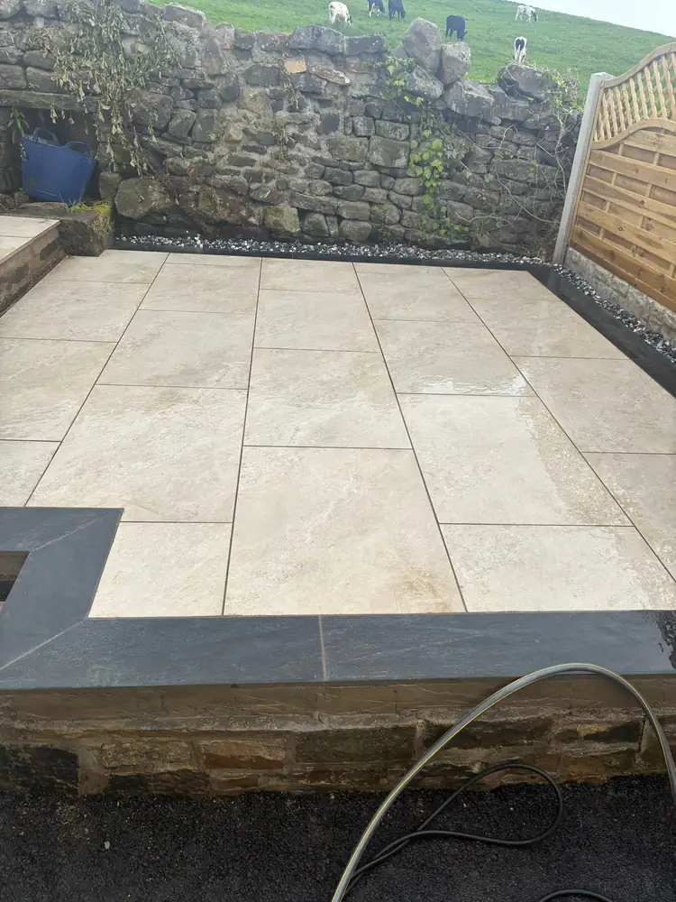 Pristine beige patio with black trim in Keighley