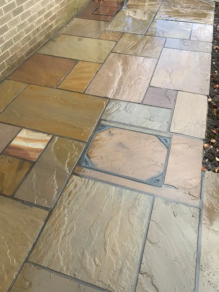 Brown sandstone patio slabs wet